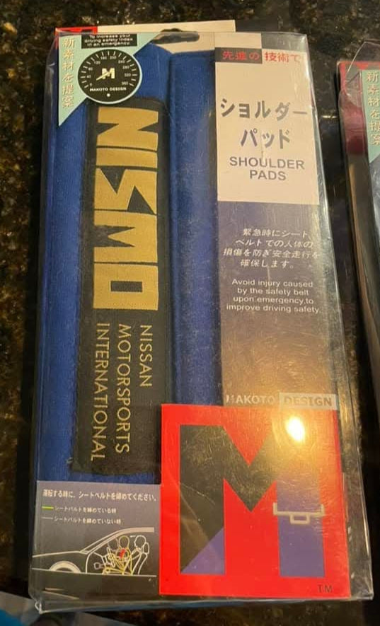 EXAMPLE PHOTO of NISMO old logo seat belt cushion pads, made by MARUTA DESIGN Japan under copyright in the 90's.