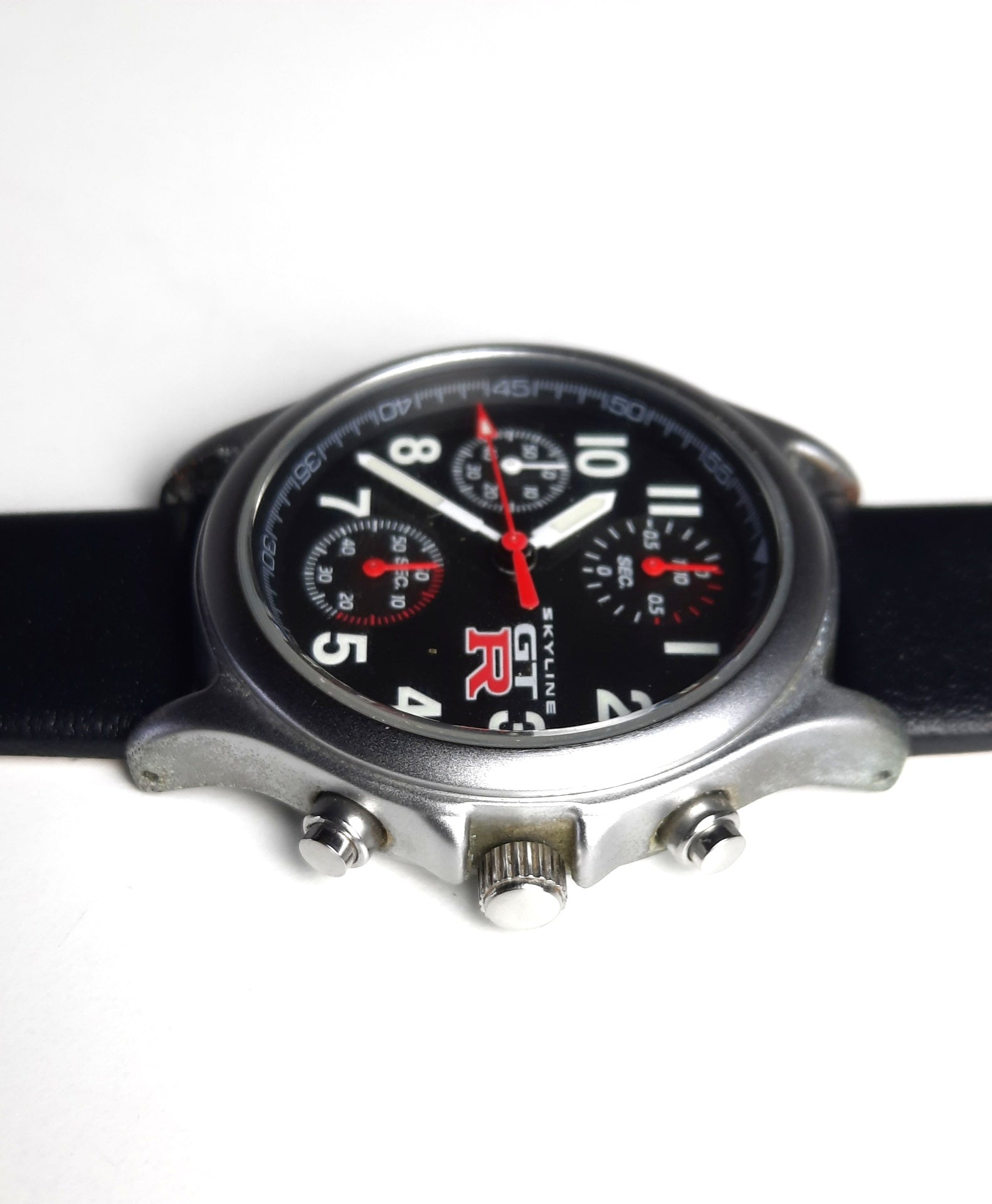 Original NISSAN SKYLINE GTR watch - left side of the case